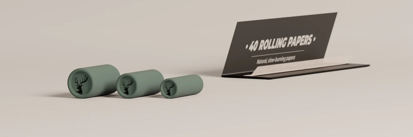 Three different sized joint filters with rolling papers, showing how they will be combined to stick