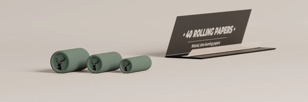 Three different sized joint filters with rolling papers, showing how they will be combined to stick