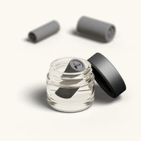A single tip with the Stag design resting in the open glass cleaning jar